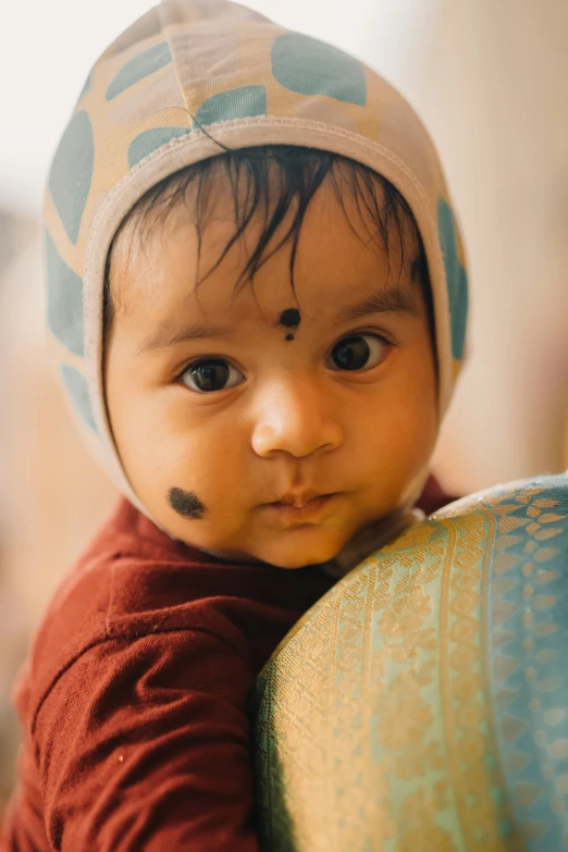 small child wearing red shirt and a blue hat