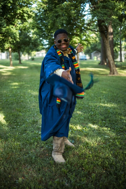 a man wearing an outfit with a blue ribbon holding a frisbee