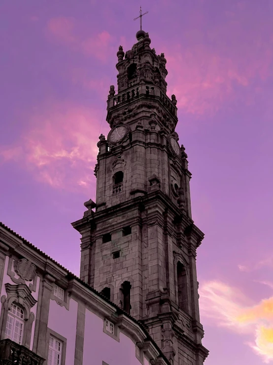 a church steeple in the middle of a purple sky