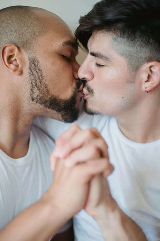 two males kissing each other with the beard trimmed
