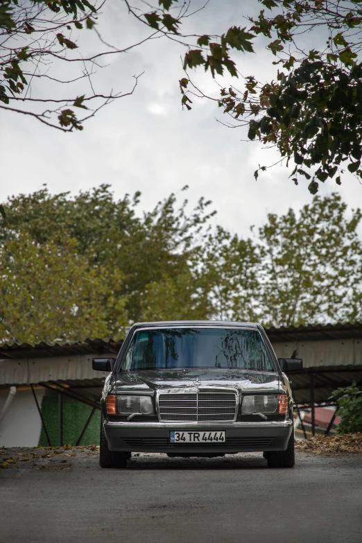 a black truck is driving down a driveway