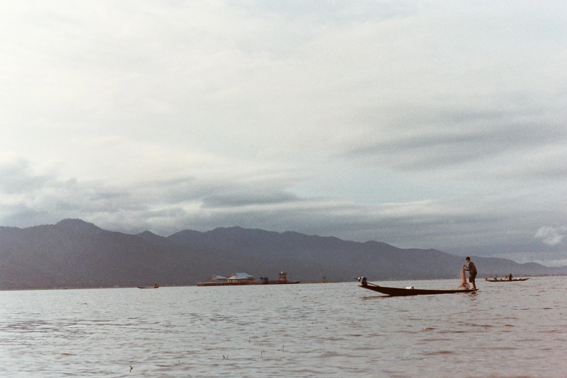 two people are riding in a small boat