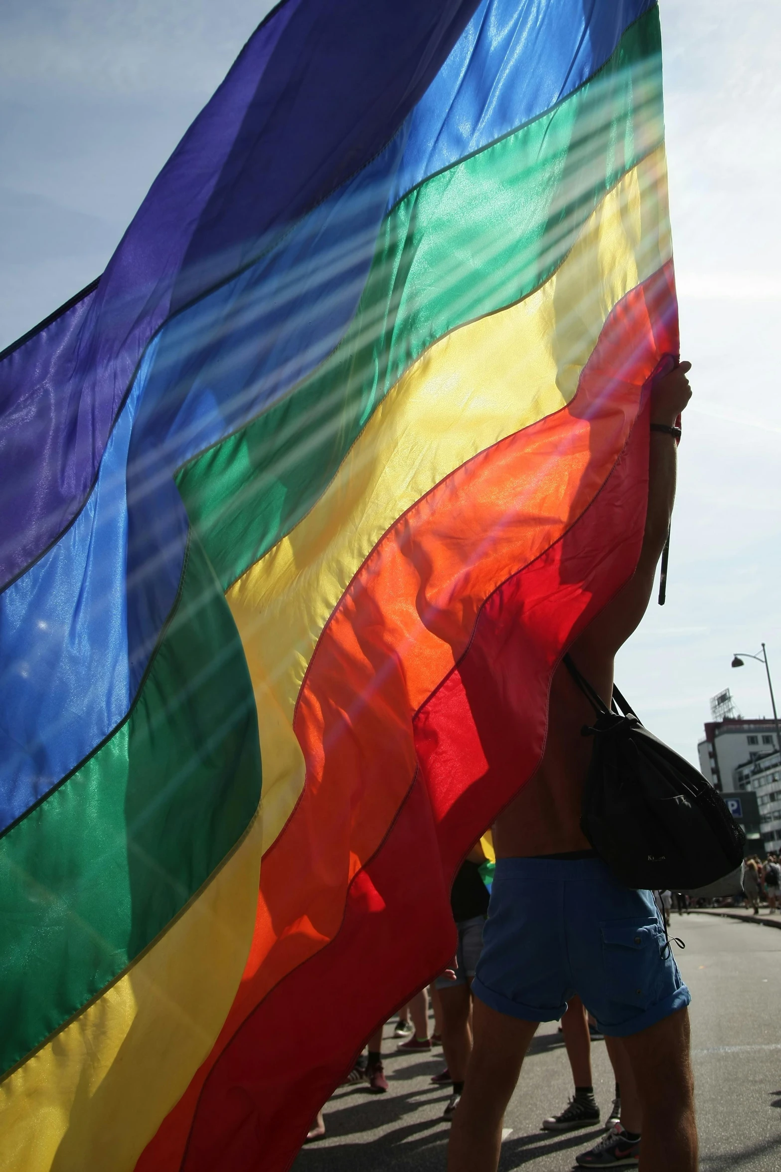 a person holding a flag and a backpack