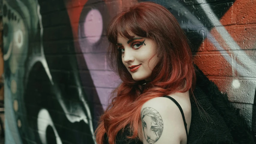 woman with red hair and long black shirt