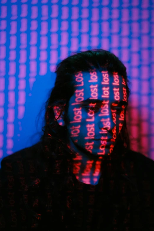 a person in dark clothing with text over their face