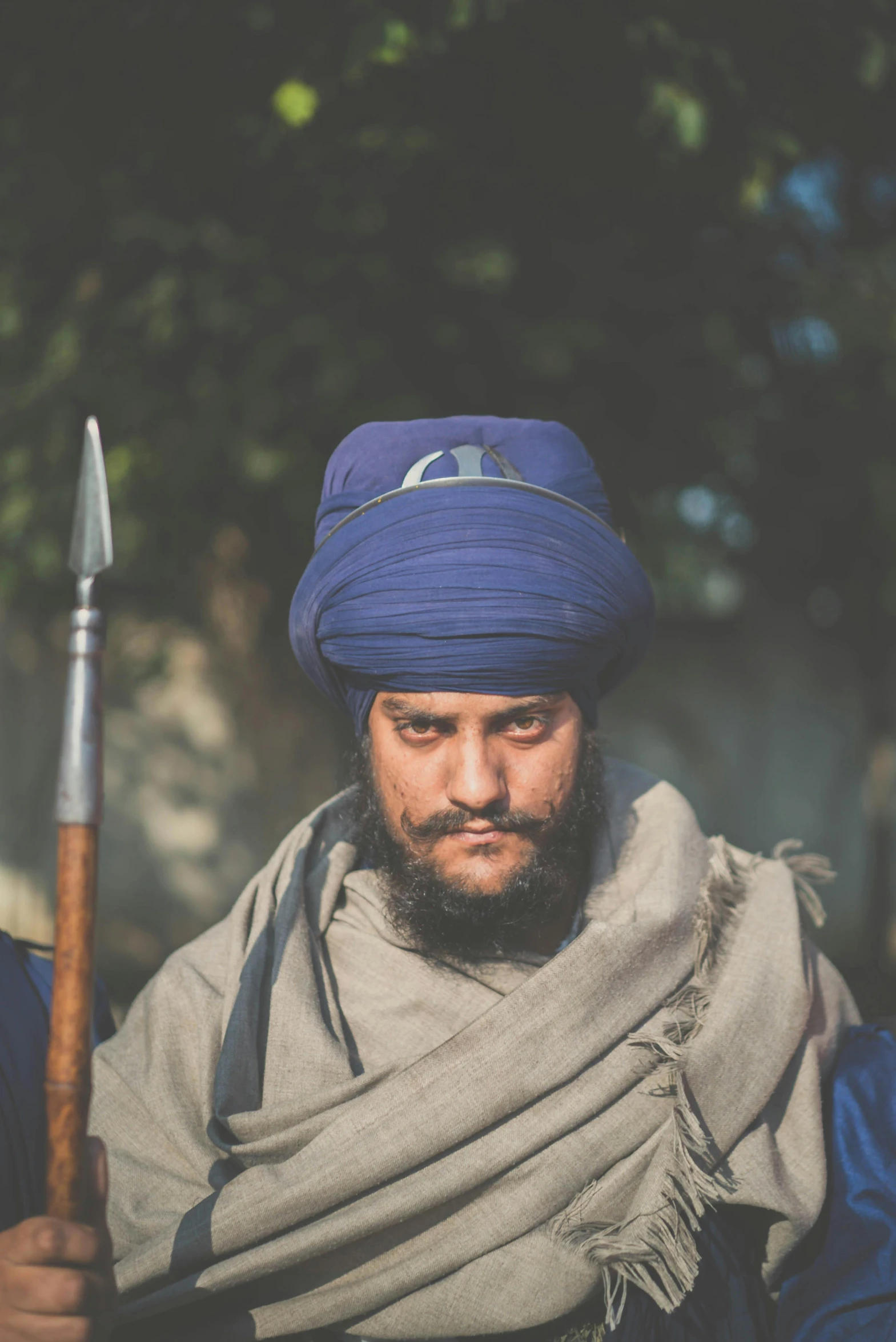 a man with a hat, carrying a knife