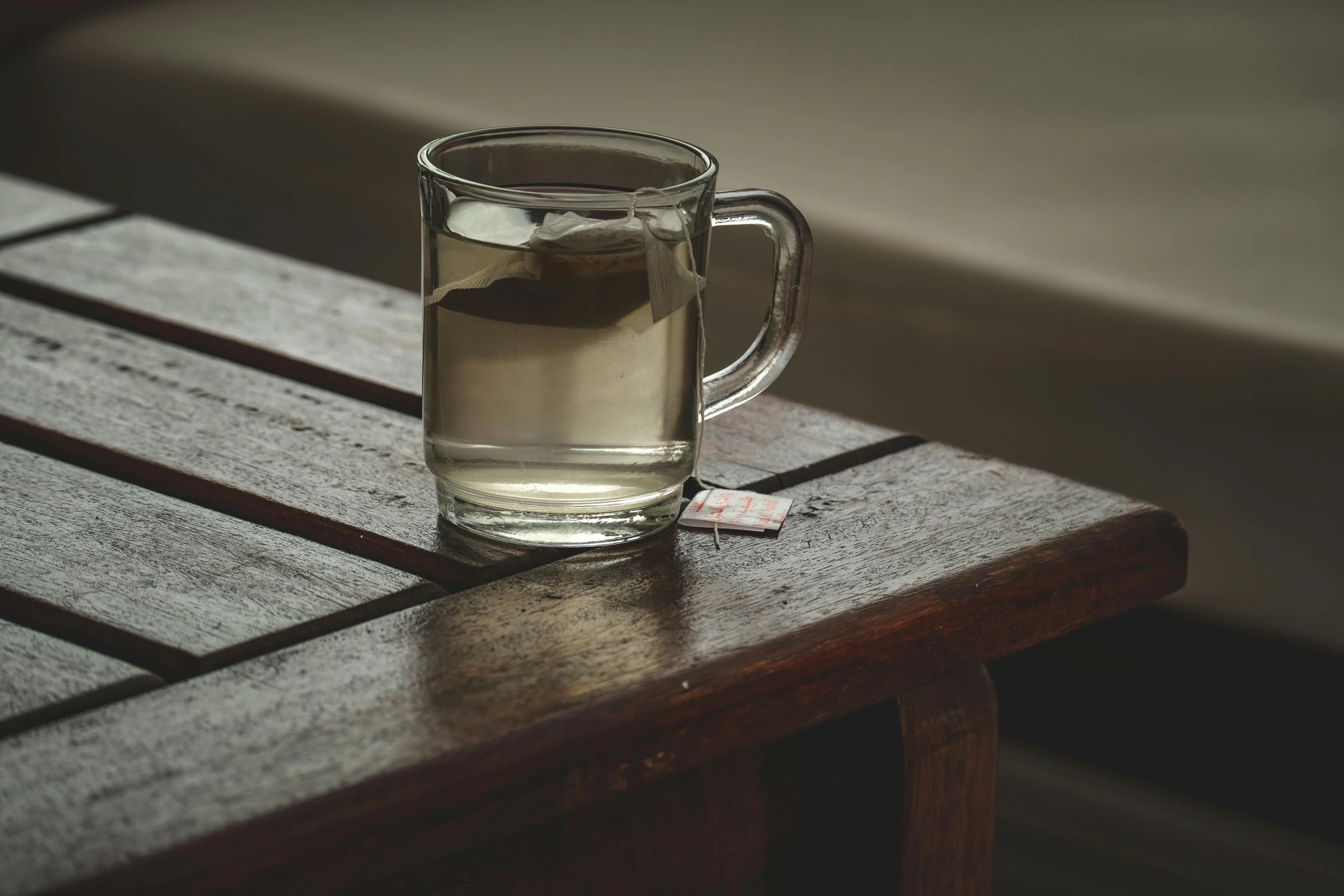 a glass mug sitting on top of a wooden table