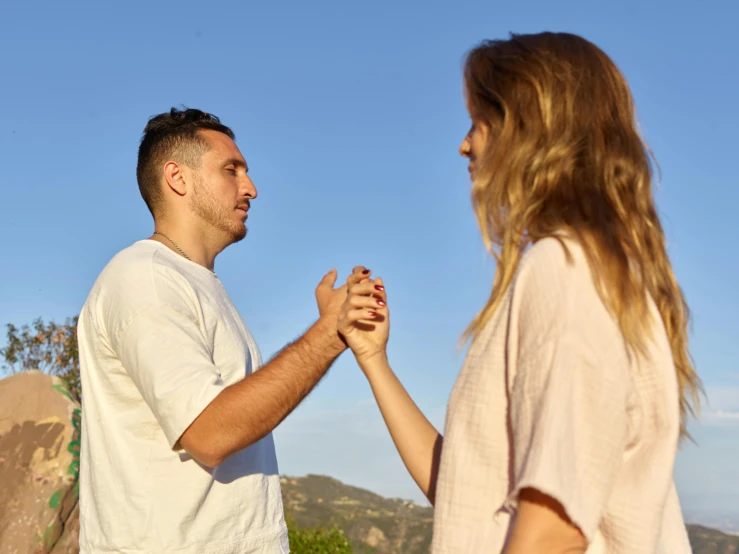 an image of two people holding hands outside