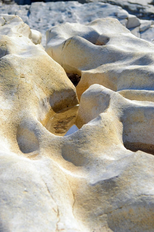 large boulders are covered with sand and water