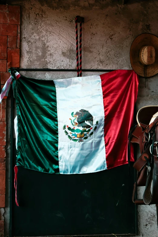 there is a mexican flag hung to dry on the building