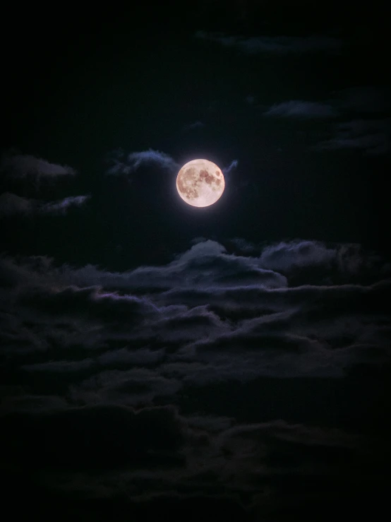 a full moon shining brightly on a night sky