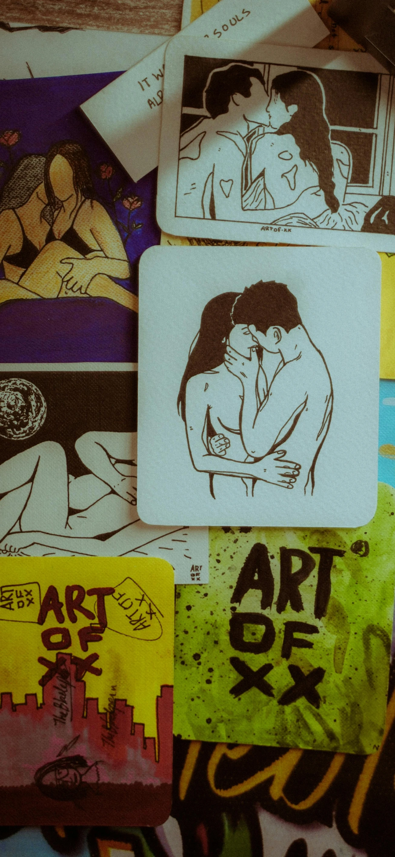 some art drawings of two people sitting and hugging