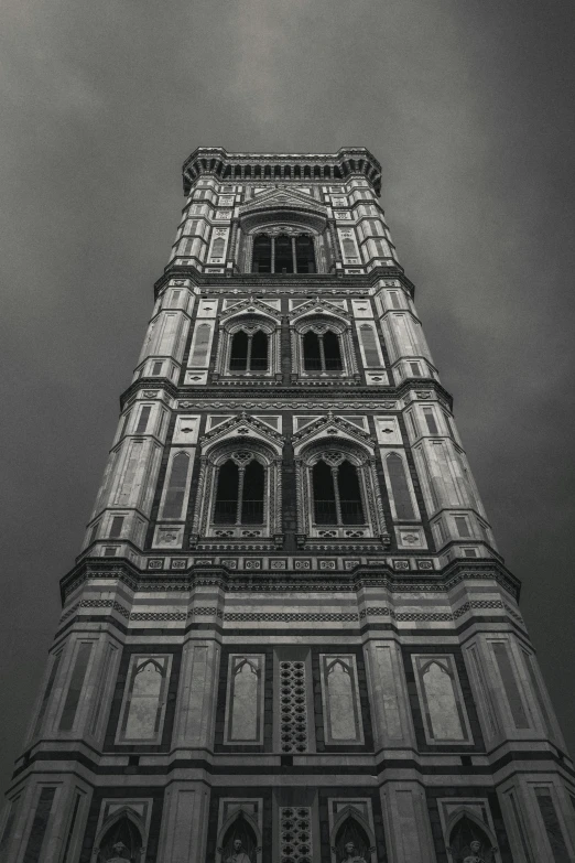 a black and white picture of the top of an ornate building