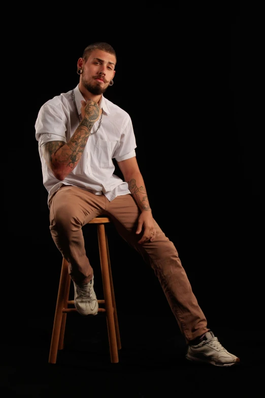 a man sitting on top of a stool