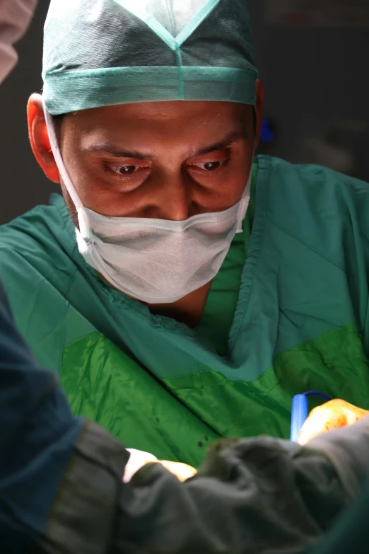 a surgeon with surgical clothes doing 