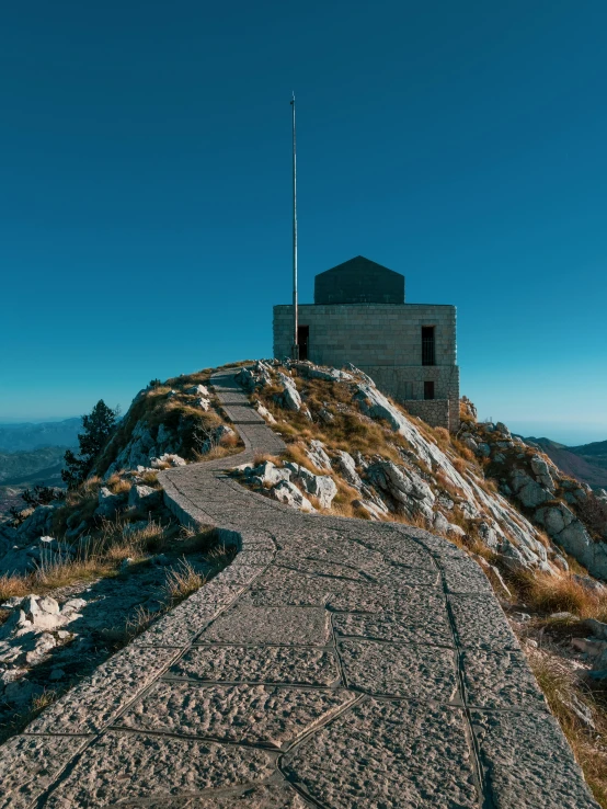 a building sitting on top of a mountain