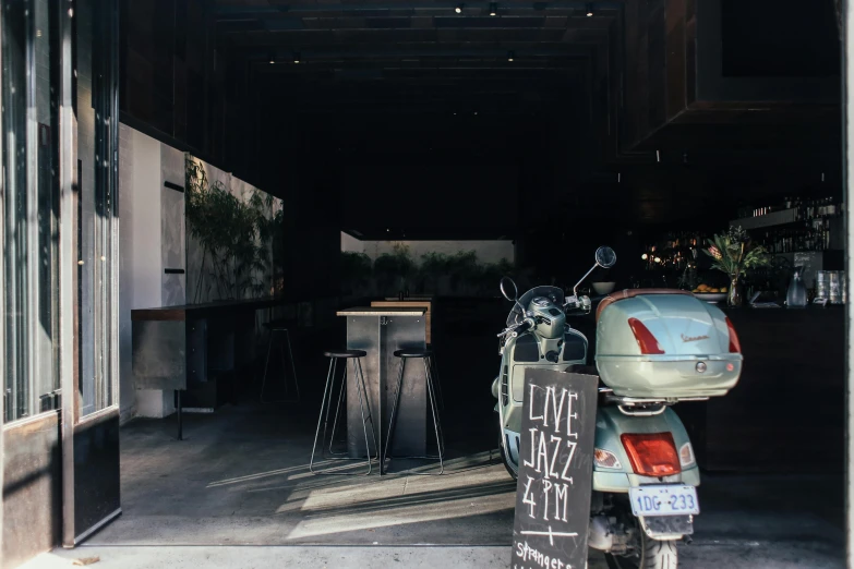 a scooter parked in a garage with its door open