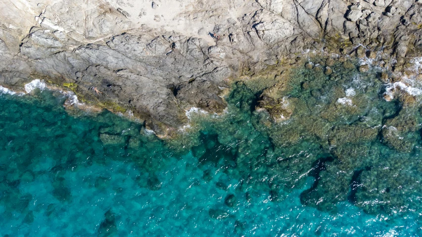 the ocean is clear and blue near a beach