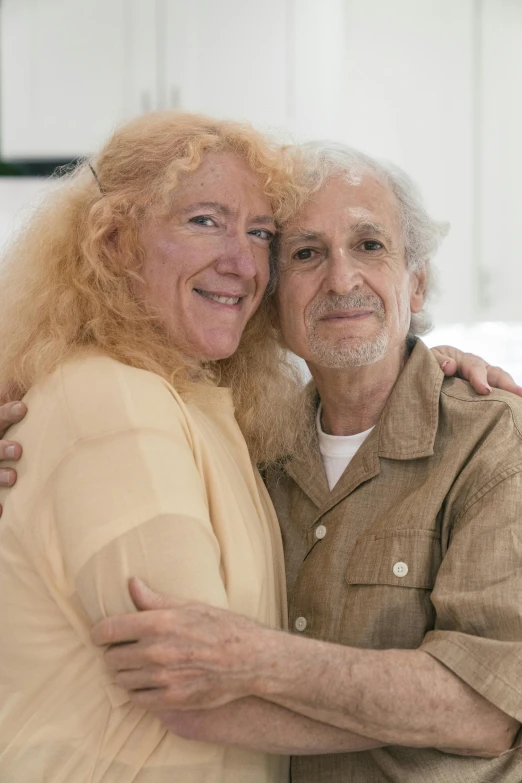 an older couple emcing in front of a painting