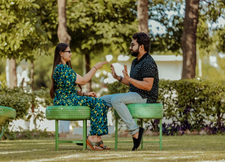 a couple sitting on a bench having fun in the park