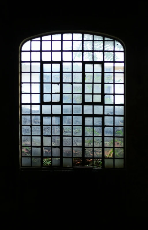 a dark window shows a hilly area beyond