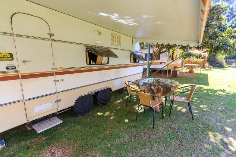 a picnic table sits under a covered outdoor camper