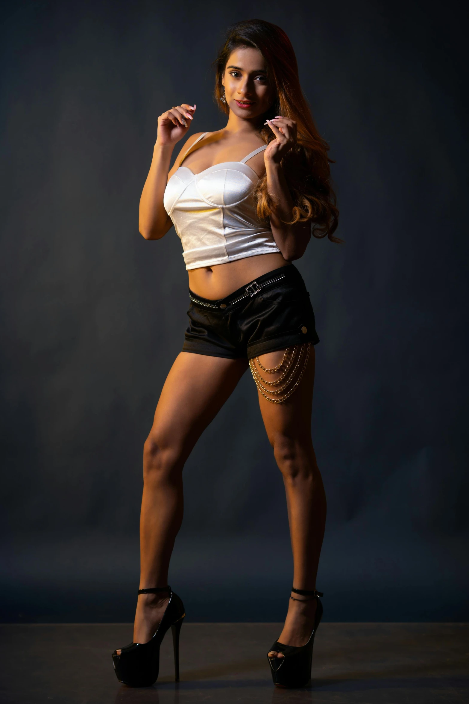 woman in shorts posing on a black background