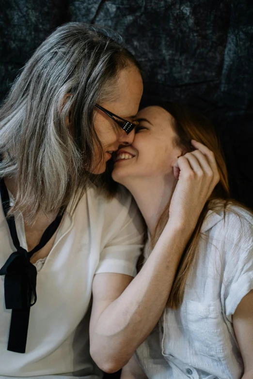 two people that are kissing each other on a couch