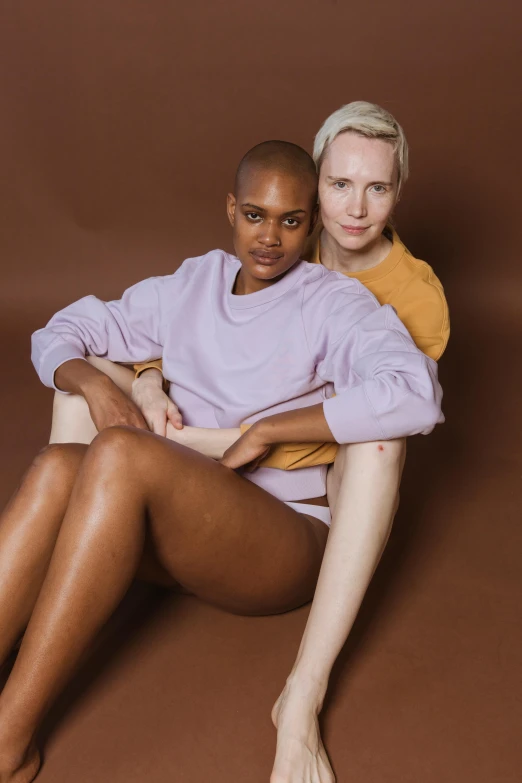 a woman in a pink sweater and man sitting next to her