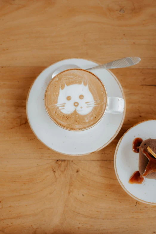 two plates with dessert items on them, one plate is made to look like a cat