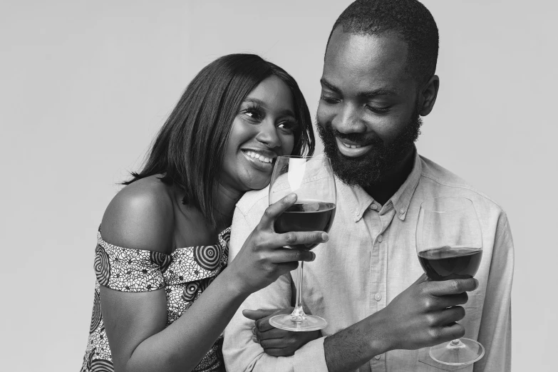 a man and woman holding wine glasses together