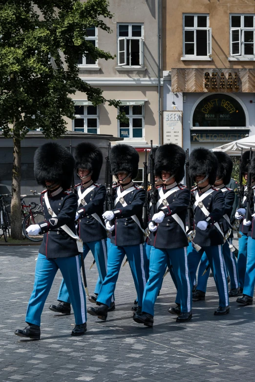 soldiers are marching in unison outside a building