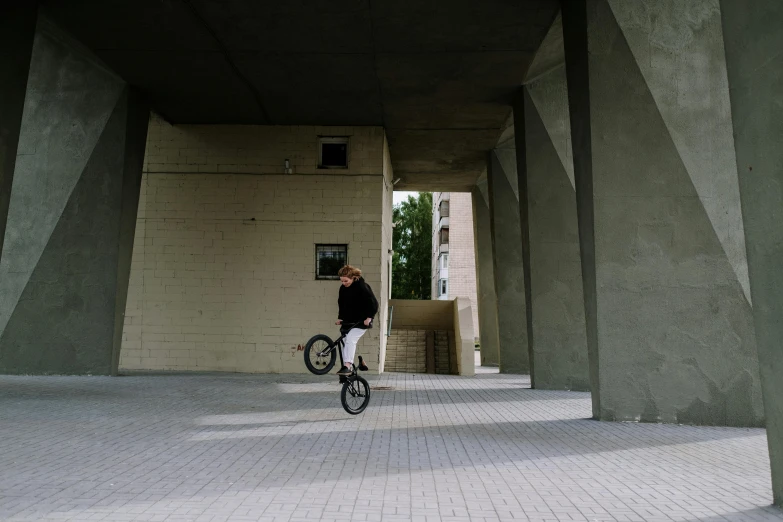 a person riding a bicycle inside of an outdoor structure