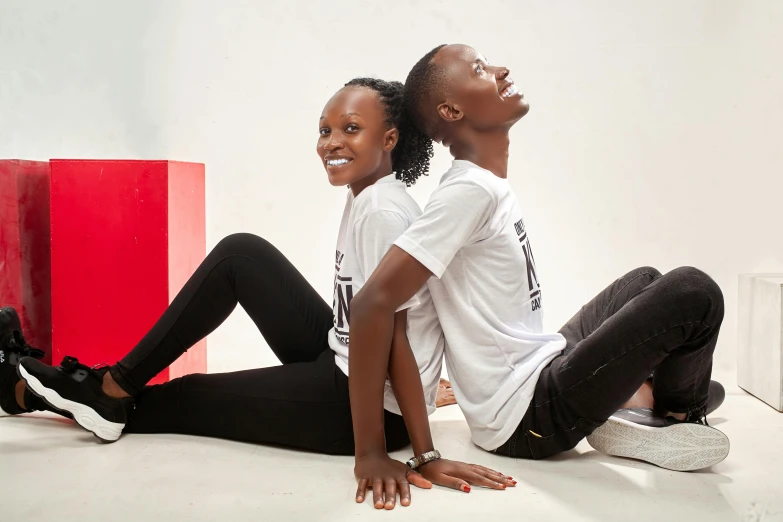 two women sitting next to each other and smiling