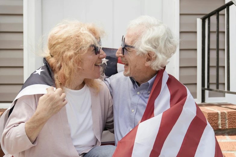 two people sitting on a bench and talking