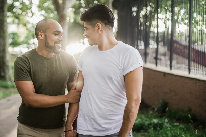 two men walking and laughing together in the sun