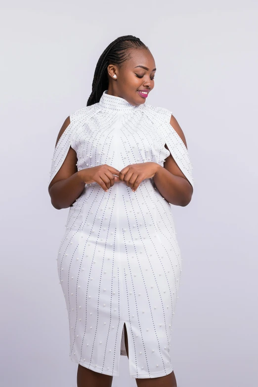 a woman wearing white stands in front of a white background