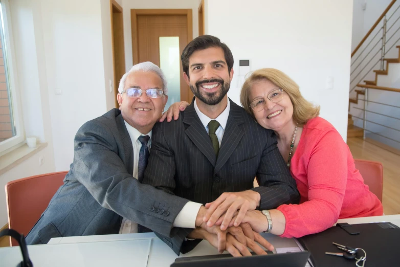 two people sitting side by side while holding hands with another person sitting next to them