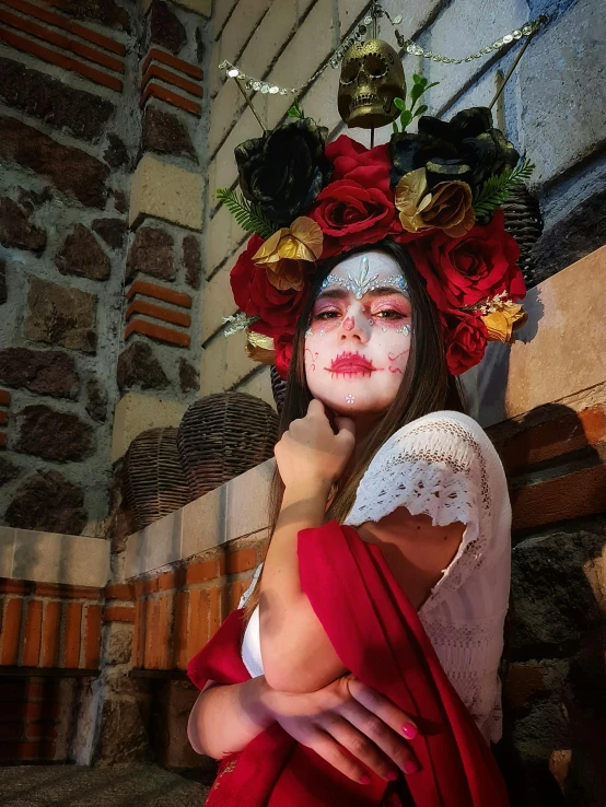 a woman with white face and red hair wearing a costume