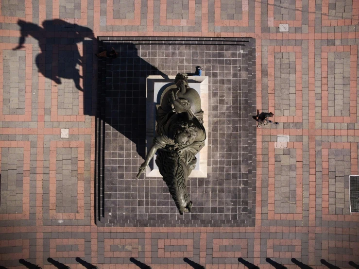 a bricked wall with a statue of an animal