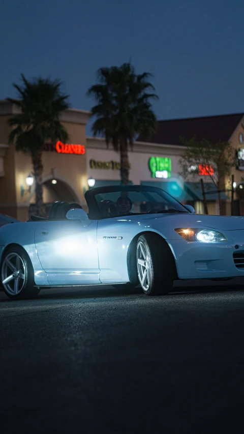 a silver car is parked on the street