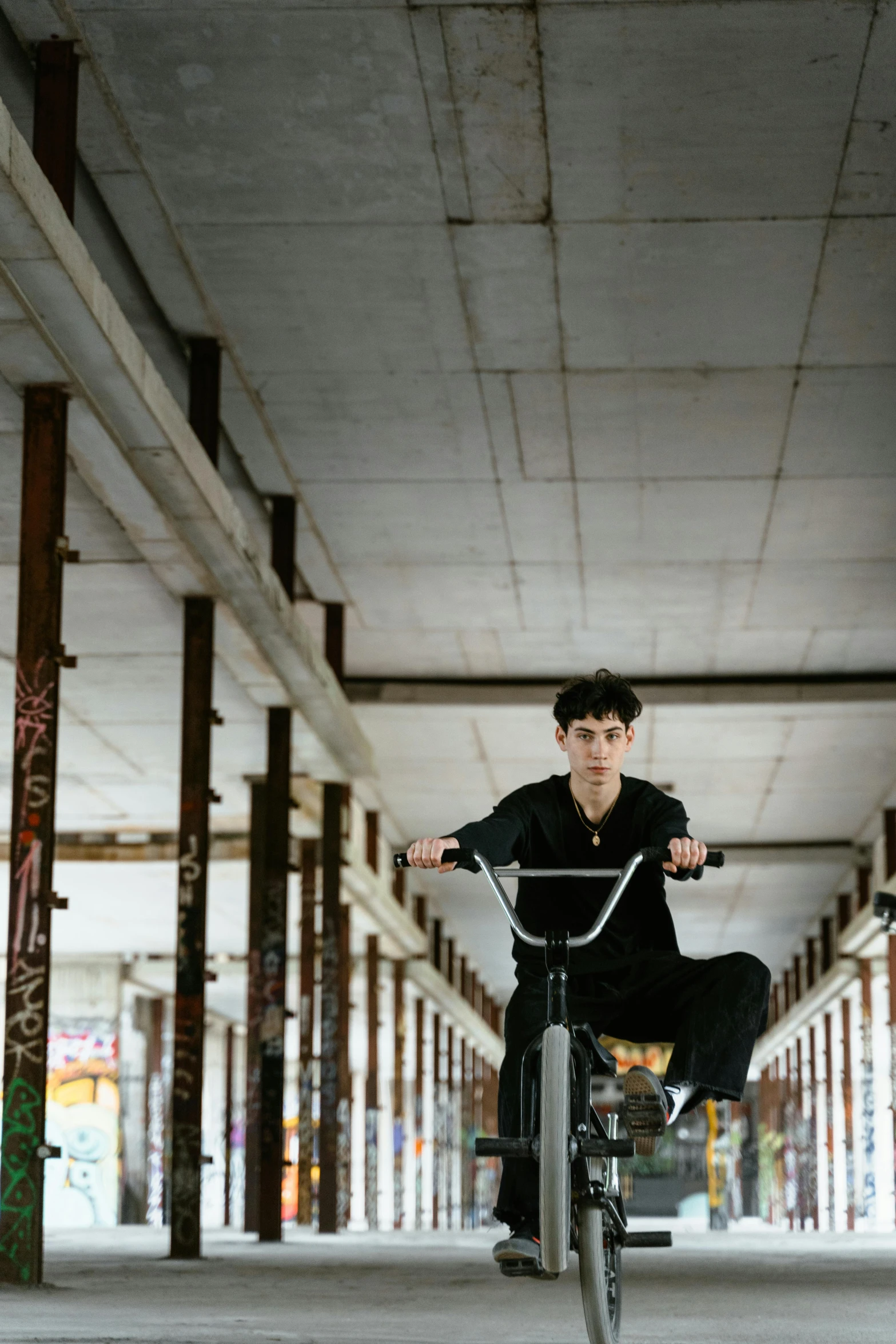 a boy is doing an odd trick on his bicycle