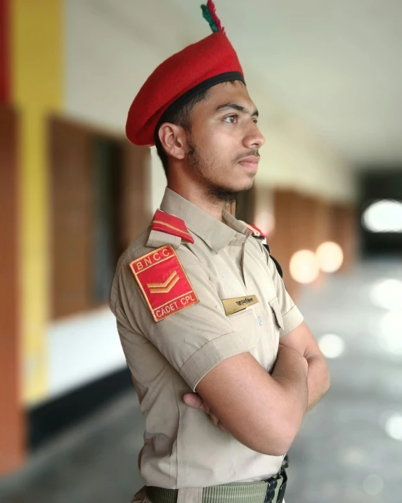 a man wearing an indian style uniform standing