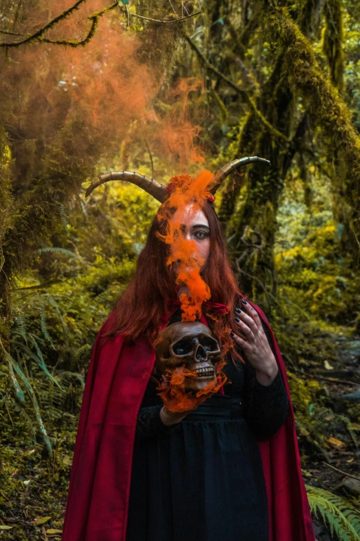 a woman wearing horns with the demon makeup