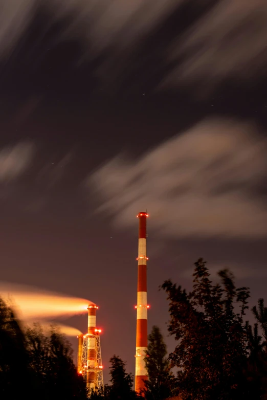 a night time view of a building with three tall towers