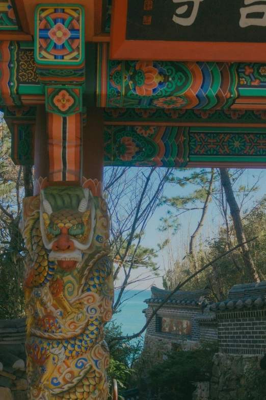 the arch of a japanese shrine has arty colors and carvings