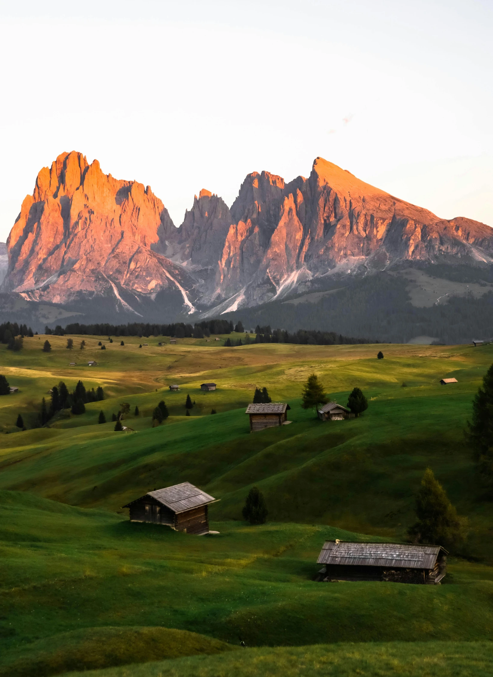 an overview of the mountains surrounding a small farm