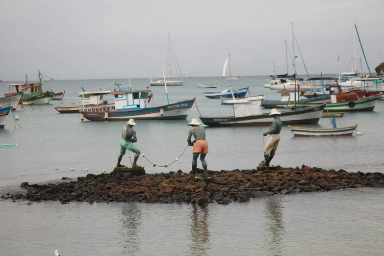 the group of men are trying to work in the water