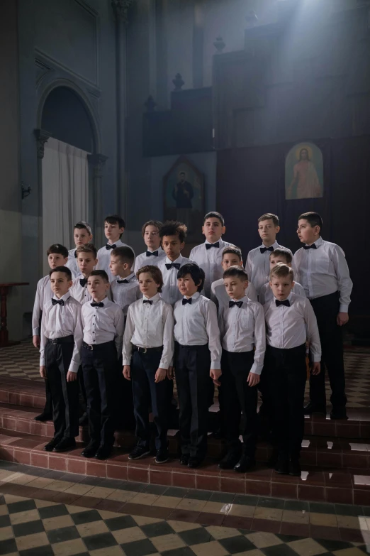 boys in white shirts and black ties posing in front of an altar