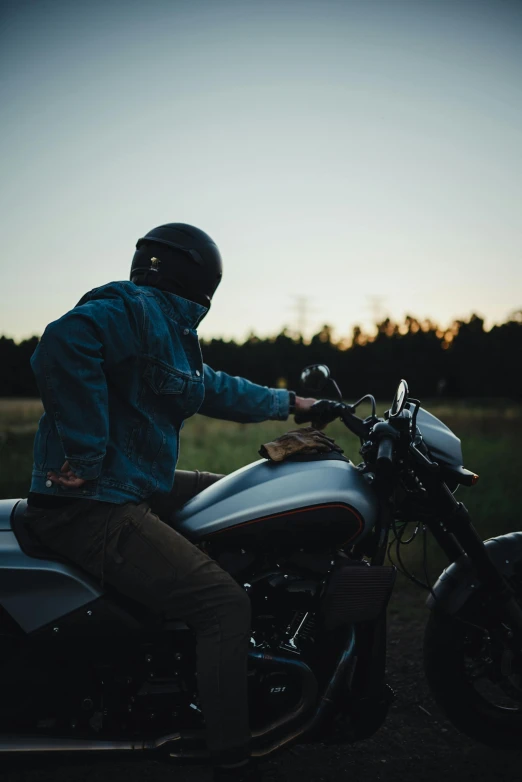 a guy in a helmet sitting on his motorcycle